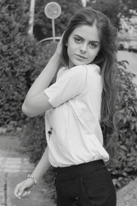 Portrait of beautiful young woman standing outdoors