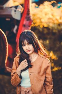 Portrait of young woman standing outdoors