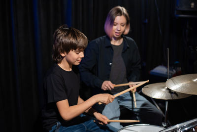 Teacher and student playing drum