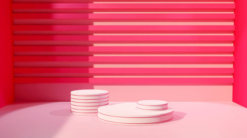 Close-up of pink stack on table against wall at home