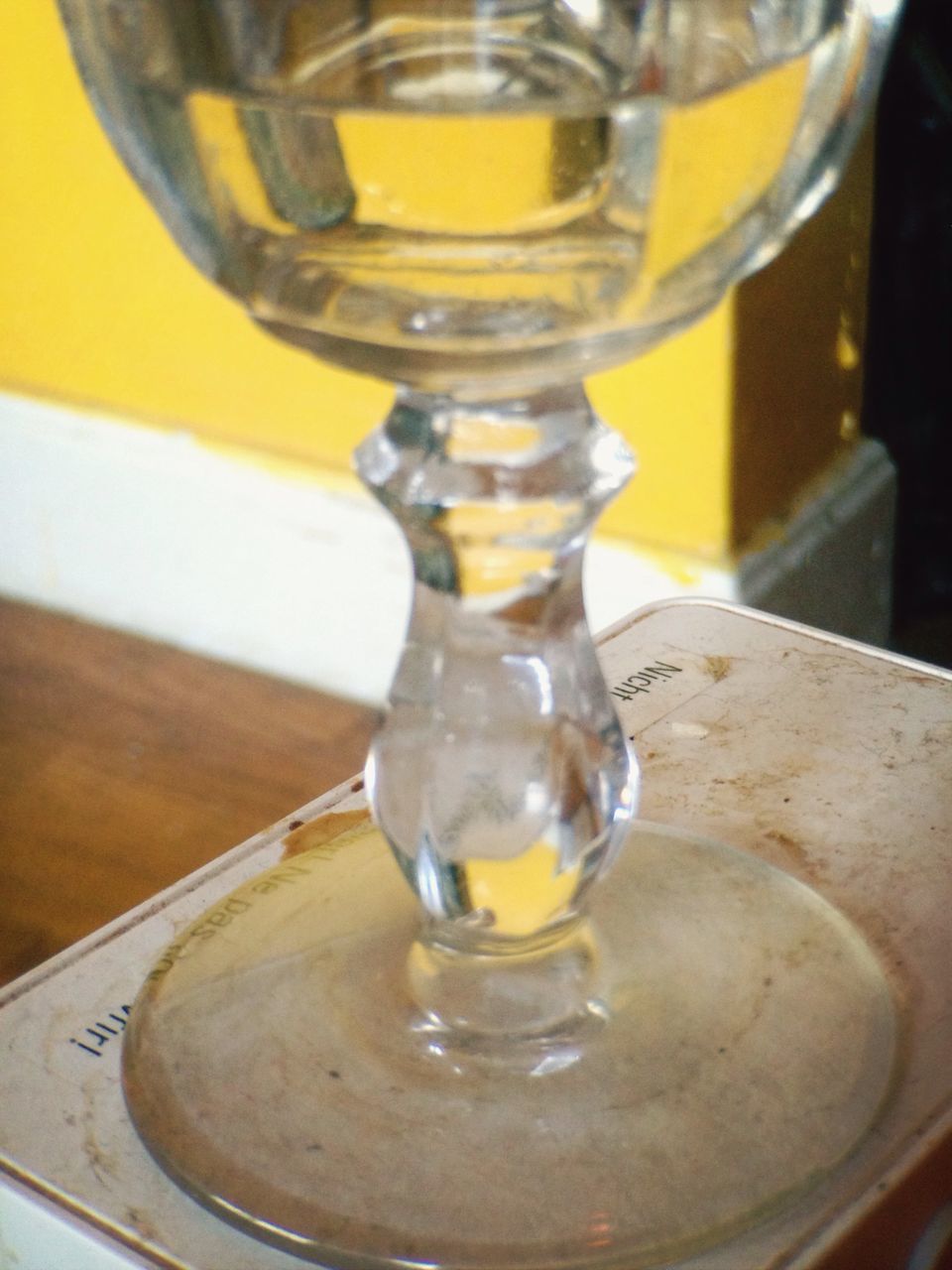 indoors, glass - material, close-up, transparent, drinking glass, table, still life, focus on foreground, drink, food and drink, refreshment, yellow, glass, reflection, freshness, water, bottle, alcohol, no people, motion