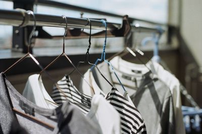 Close-up of cloths on coathangers at home