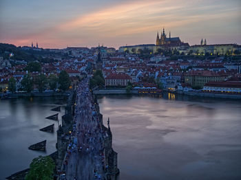 Bridge over river against buildings in city