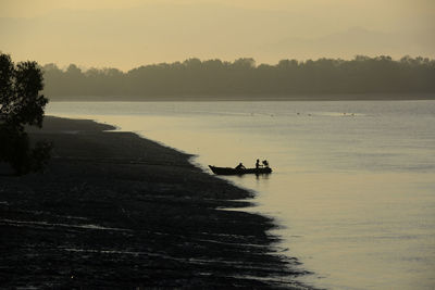 Two remote people leaving by boat