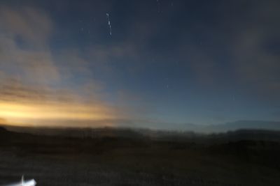 Scenic view of landscape against sky at night