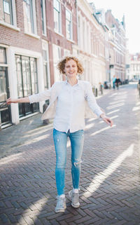 Cheerful woman walking on street in city