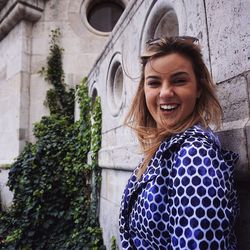 Portrait of beautiful smiling young woman by buda castle