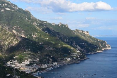 Scenic view of sea and mountains against sky
