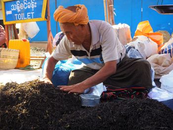 Rear view of man working at market stall