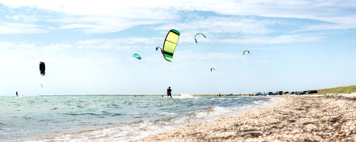 People on beach against sky