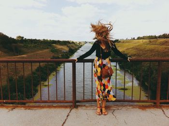 Woman shaking head on bridge