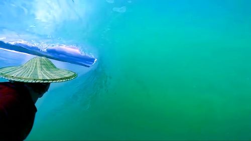 Midsection of person swimming in sea