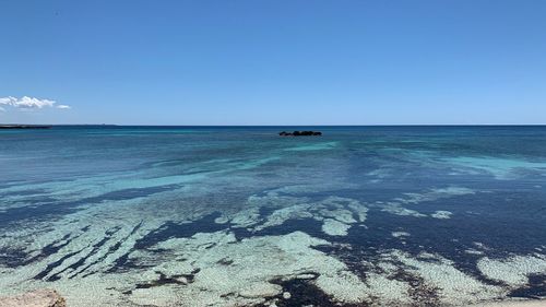 Scenic view of sea against blue sky