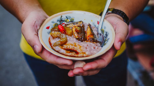 Midsection of man holding food