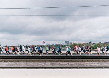 Athletes running on railway bridge during marathon