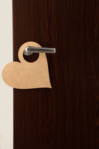 Close-up of heart shape do not enter sign on doorknob