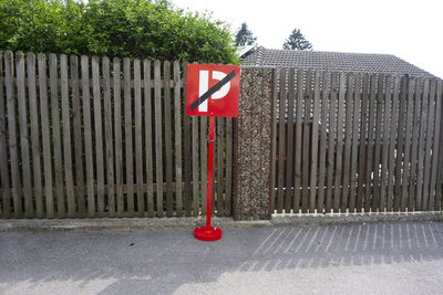 Road sign against trees in city