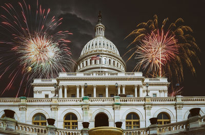 Low angle view of firework display at night