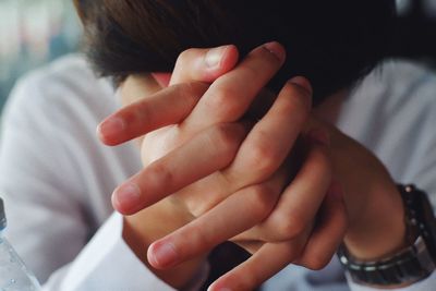 Close-up of woman hand on bed