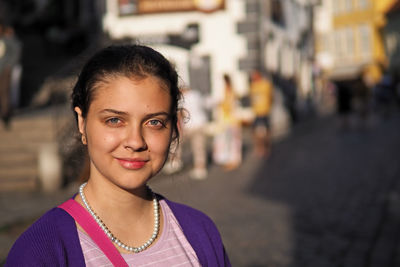 Portrait of a smiling young woman in city