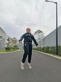 Full length of man standing on road against sky