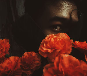 Close-up portrait of woman with red flower