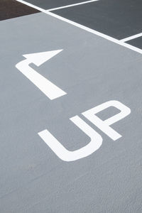 High angle view of arrow sign on road