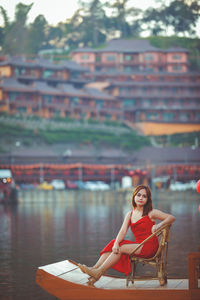 Asian woman wearing cheongsam traditional red dress on chinese new year travel.