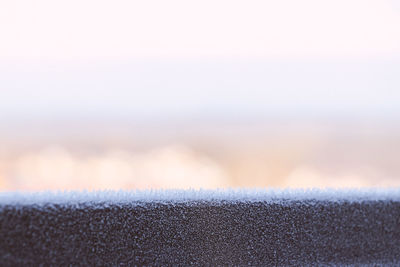 Close-up of frozen land against sky