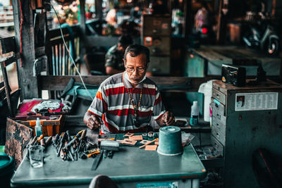 Full length of man working on table