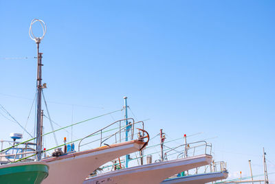 Low angle view of sailboat against clear blue sky