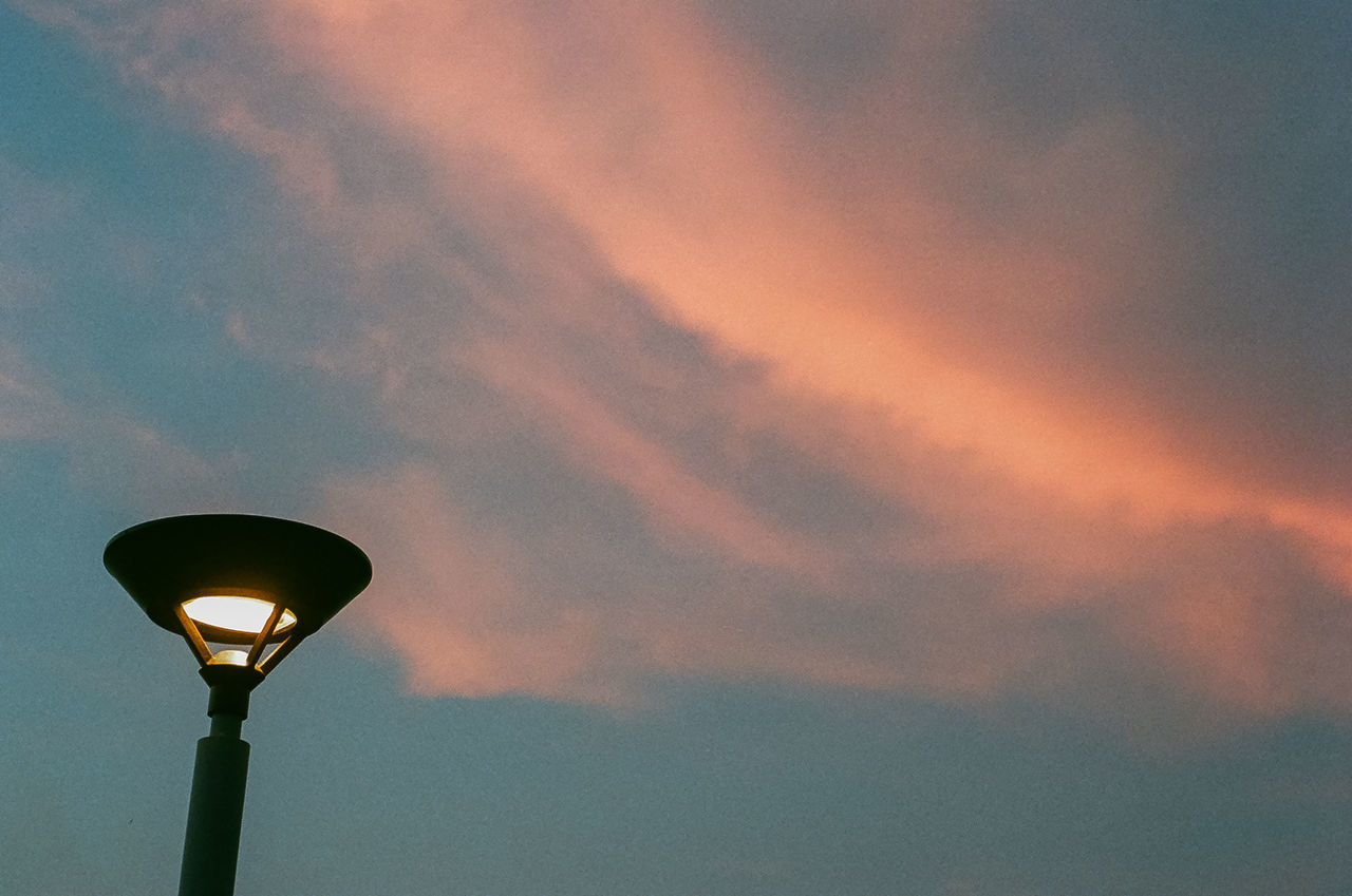 LOW ANGLE VIEW OF ILLUMINATED STREET LIGHT AGAINST SKY