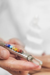 Close-up of hand holding multi colored object