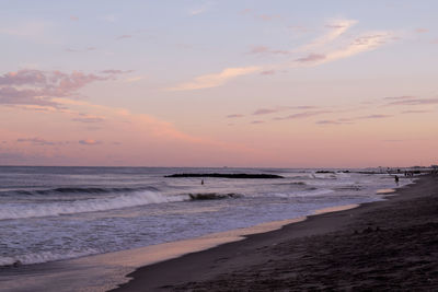 Scenic view of beach against sky during sunset