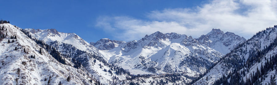 Panoramic view of snowcapped mountains against sky