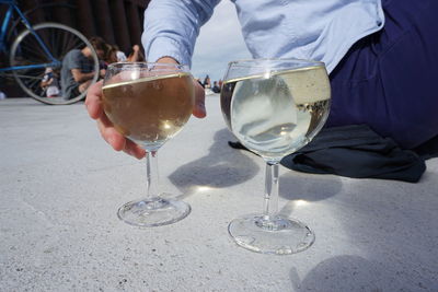 Reflection of people in glass on table