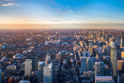 Aerial view of cityscape against sky during sunset