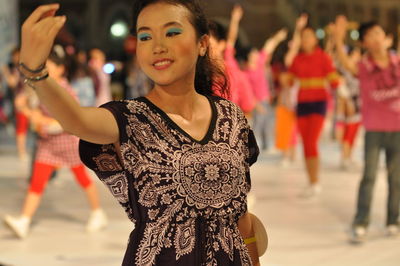 Smiling artist performing traditional dance during carnival