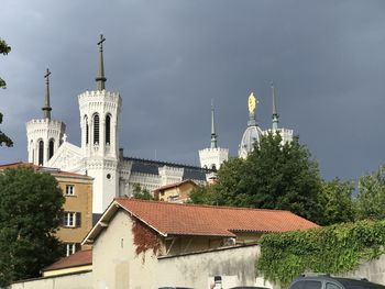 Buildings in city against sky