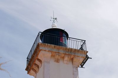 Low angle view of lighthouse against building