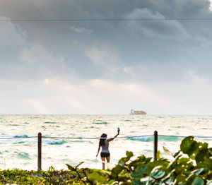 Man standing on beach against sky