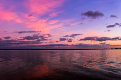 Scenic view of sea against romantic sky at sunset