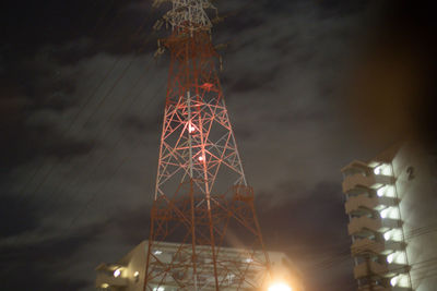 Low angle view of illuminated tower against sky