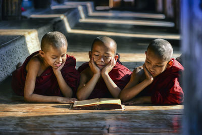 Monks reading book at temple