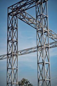 Low angle view of electricity pylon against sky