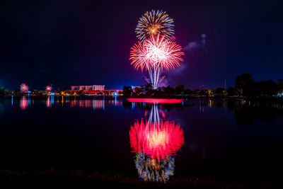 Firework display over river at night