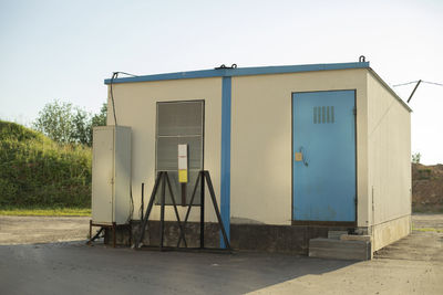 Entrance of building against clear blue sky