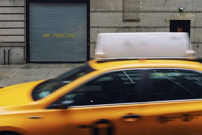 Blurred motion of yellow car on street