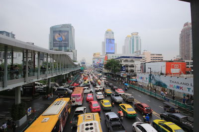 Cars on road in city against sky