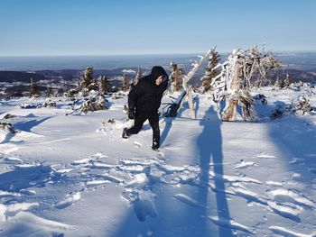 Full length of woman on snowy field against sky